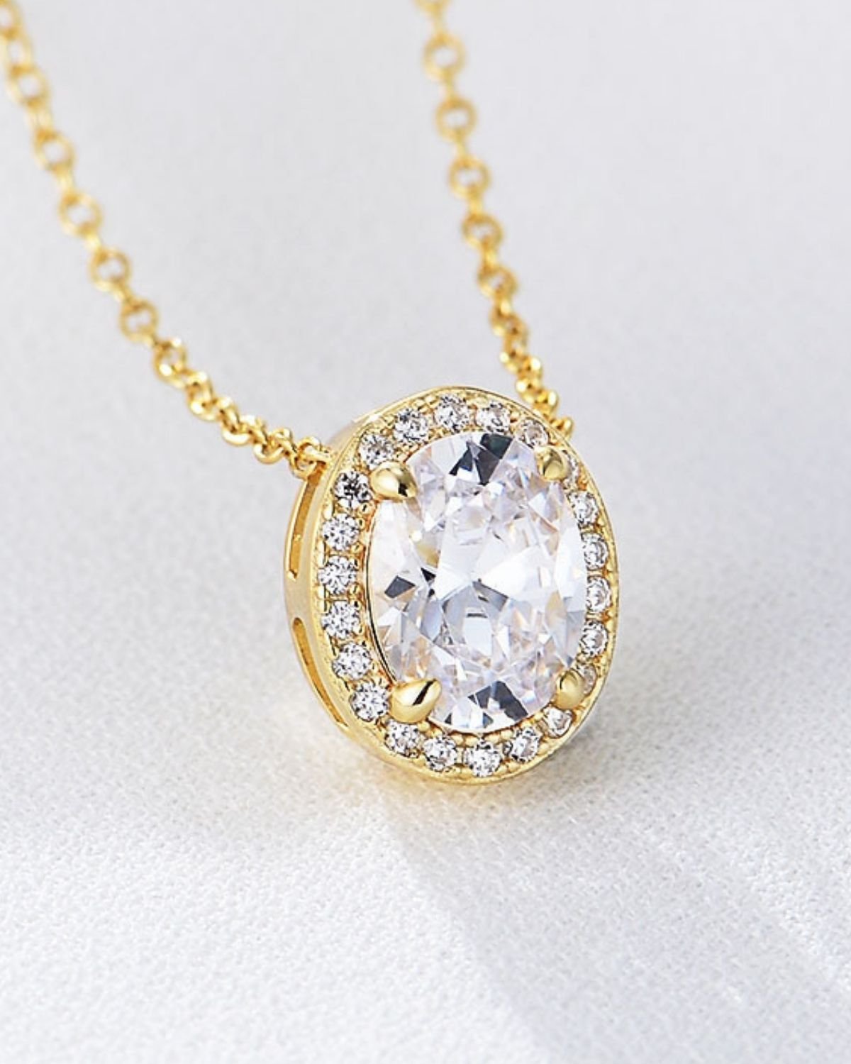 plated-oval-halo-pendant-necklace.jpg Elegant oval halo necklace in gold